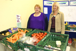 Volunteers With The Various Goods On Offer