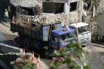 Lorry Loaded With Debris Passes The Riverside Hotel