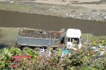 Loaded Lorry Drives Past The River