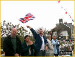 John Stratton Gives A Cheery Wave of His Flag