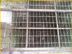 A Metal Grid Covers A Deep Hole